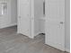 Bedroom showcasing gray floors and a doorway with a view into a modern renovated bathroom at 26098 Six Points Rd, Sheridan, IN 46069