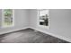 Bright bedroom with gray floors, white trim, and natural light streaming through two large windows at 26098 Six Points Rd, Sheridan, IN 46069