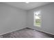 Bright bedroom features new paint, gray flooring and a large window view at 26098 Six Points Rd, Sheridan, IN 46069
