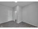Neutral bedroom features new paint, gray flooring and closet and access doors at 26098 Six Points Rd, Sheridan, IN 46069