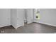 A bedroom featuring gray floors, two closets, and a view of the adjacent renovated bathroom at 26098 Six Points Rd, Sheridan, IN 46069