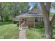 Inviting home exterior with a charming front porch, mature landscaping, and a walkway at 26098 Six Points Rd, Sheridan, IN 46069