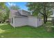 Side exterior view of home featuring gray siding, shingled roof, and manicured lawn at 26098 Six Points Rd, Sheridan, IN 46069