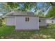 Side view of home featuring neutral siding, with a glimpse of mature trees at 26098 Six Points Rd, Sheridan, IN 46069