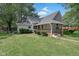 Beautiful home with a covered front porch, complemented by neat landscaping and green grass at 26098 Six Points Rd, Sheridan, IN 46069