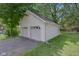 Detached garage with white siding and a two-car garage offers ample parking at 26098 Six Points Rd, Sheridan, IN 46069