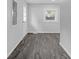 Bright hallway with gray wood-look flooring and a window providing natural light at 26098 Six Points Rd, Sheridan, IN 46069