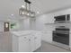 Bright kitchen with white cabinetry, stainless steel appliances, and island at 26098 Six Points Rd, Sheridan, IN 46069