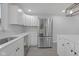 Bright kitchen features white cabinetry, stainless steel appliances, and quartz countertops at 26098 Six Points Rd, Sheridan, IN 46069