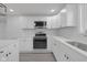 Bright kitchen features white cabinetry, stainless steel appliances, and quartz countertops at 26098 Six Points Rd, Sheridan, IN 46069