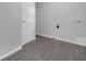Laundry room with new paint, gray flooring and connections for machines at 26098 Six Points Rd, Sheridan, IN 46069