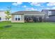 Well-maintained backyard with lush lawn, showcasing the sunroom extension of the home at 2612 Ruffian Dr, Westfield, IN 46074