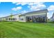 Spacious backyard featuring a well-manicured lawn and a sunroom attached to the house at 2612 Ruffian Dr, Westfield, IN 46074