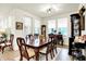 Bright dining room with beautiful wood table, chairs, large windows, and elegant display cabinets at 2612 Ruffian Dr, Westfield, IN 46074