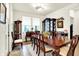 Bright dining room showcasing a hardwood table set with chairs and a display cabinet with natural light at 2612 Ruffian Dr, Westfield, IN 46074