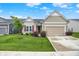 Inviting home featuring a two-car garage and neatly kept front yard with fresh, green grass at 2612 Ruffian Dr, Westfield, IN 46074