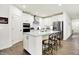 Bright kitchen boasts white cabinets, a large island, and stainless steel appliances at 2612 Ruffian Dr, Westfield, IN 46074