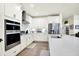 Well-lit kitchen with stainless steel appliances, white cabinets, and spacious countertops at 2612 Ruffian Dr, Westfield, IN 46074