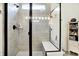 Modern walk-in shower with sleek tile, glass enclosure, and convenient bench at 2612 Ruffian Dr, Westfield, IN 46074