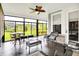 Relaxing sunroom with large windows, comfortable seating, and a ceiling fan at 2612 Ruffian Dr, Westfield, IN 46074