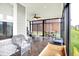 Bright sunroom featuring tile flooring, ceiling fan, wicker seating, and views of the landscaped yard at 2612 Ruffian Dr, Westfield, IN 46074