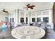 Inviting sunroom with tile flooring, ceiling fans, and ample seating around a unique tiled table at 2612 Ruffian Dr, Westfield, IN 46074