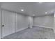 This basement has neutral walls and carpet and multiple doors at 2860 Winthrop Ave, Indianapolis, IN 46205