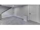 This basement has neutral walls and carpet and multiple doors at 2860 Winthrop Ave, Indianapolis, IN 46205