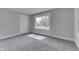 An empty bedroom featuring gray carpet and a window providing lots of natural light at 2860 Winthrop Ave, Indianapolis, IN 46205