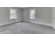 Empty bedroom featuring two windows offering natural light and plush gray carpet flooring at 2860 Winthrop Ave, Indianapolis, IN 46205