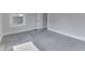 This bedroom has neutral walls and carpet and a bright window at 2860 Winthrop Ave, Indianapolis, IN 46205