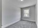 This bedroom has neutral walls and carpet and a bright window at 2860 Winthrop Ave, Indianapolis, IN 46205