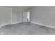 An empty bedroom featuring plush gray carpet and an open doorway to an adjoining room at 2860 Winthrop Ave, Indianapolis, IN 46205
