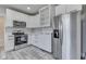 This kitchen features stainless steel appliances, sleek white cabinetry, and stylish gray flooring at 2860 Winthrop Ave, Indianapolis, IN 46205