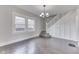 Bright living room features hardwood floors, natural light, staircase, and a modern chandelier at 2860 Winthrop Ave, Indianapolis, IN 46205