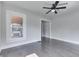 Lovely living room features hardwood floors, a ceiling fan, and a seamless transition to other rooms at 2860 Winthrop Ave, Indianapolis, IN 46205