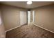 Cozy bedroom featuring neutral walls and carpet, with a view to another room at 2951 S Elizabeth St, Indianapolis, IN 46203