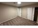 Bedroom featuring neutral walls and carpet, with closet and view to another room at 2951 S Elizabeth St, Indianapolis, IN 46203