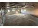 Open garage area with concrete flooring and a door leading to the outside at 2951 S Elizabeth St, Indianapolis, IN 46203