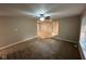 Open-concept living room featuring plush carpet and a ceiling fan with a light fixture at 2951 S Elizabeth St, Indianapolis, IN 46203