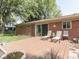 Brick home featuring a wood deck with patio furniture and flowers at 343 E Waterbury Rd, Indianapolis, IN 46227