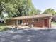 Brick home featuring a wood deck, patio, and driveway at 343 E Waterbury Rd, Indianapolis, IN 46227