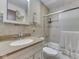 Neutral bathroom featuring a vanity, toilet, and shower-tub combination with glass doors at 343 E Waterbury Rd, Indianapolis, IN 46227