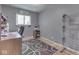Simple bedroom or office space featuring desk, shelving, and large window at 343 E Waterbury Rd, Indianapolis, IN 46227