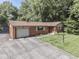 Lovely single-story brick home featuring an attached garage, beautiful landscaping, and a paved driveway at 343 E Waterbury Rd, Indianapolis, IN 46227