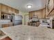 Bright kitchen with stainless steel appliances, wood cabinets, and a large island countertop at 343 E Waterbury Rd, Indianapolis, IN 46227