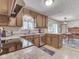 Cozy kitchen with wood cabinets, stainless appliances, and an adjacent dining area with natural light at 343 E Waterbury Rd, Indianapolis, IN 46227