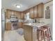 Traditional kitchen featuring wooden cabinetry, stainless steel appliances, and a breakfast bar with seating at 343 E Waterbury Rd, Indianapolis, IN 46227