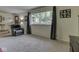 Open living room featuring a large window, neutral carpet, and a cozy recliner at 343 E Waterbury Rd, Indianapolis, IN 46227
