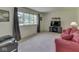 Comfortable living room featuring a large window, neutral carpet, and cozy seating at 343 E Waterbury Rd, Indianapolis, IN 46227